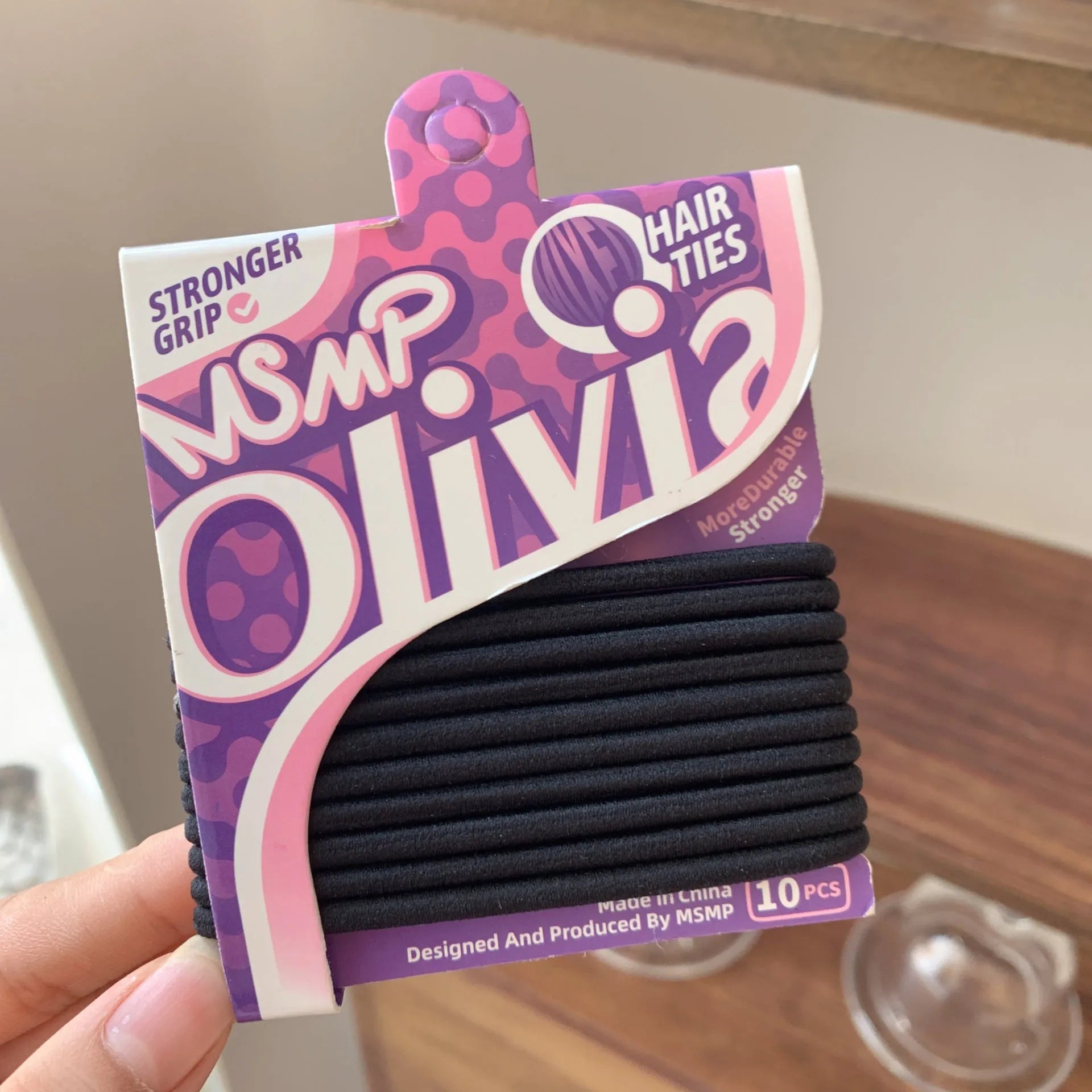 Set of braided elastic hair bands in assorted candy colours on a white background.