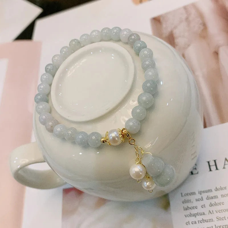 Emerald green jade bracelet with Chinese gourd design elements