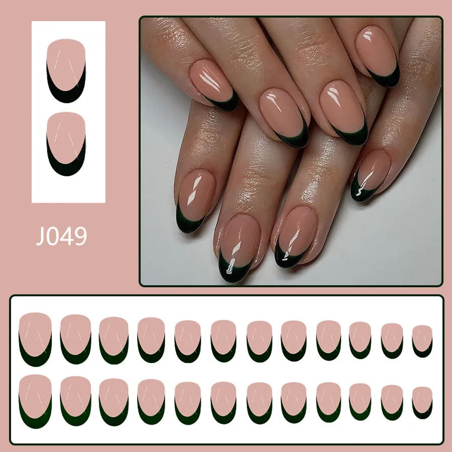 24 black French style false nails with short almond shapes laid out on a surface.