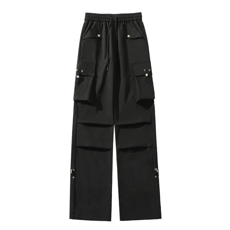 Women's plus size loose-fit waterproof trousers in black, shown with elasticated waist and straight leg.