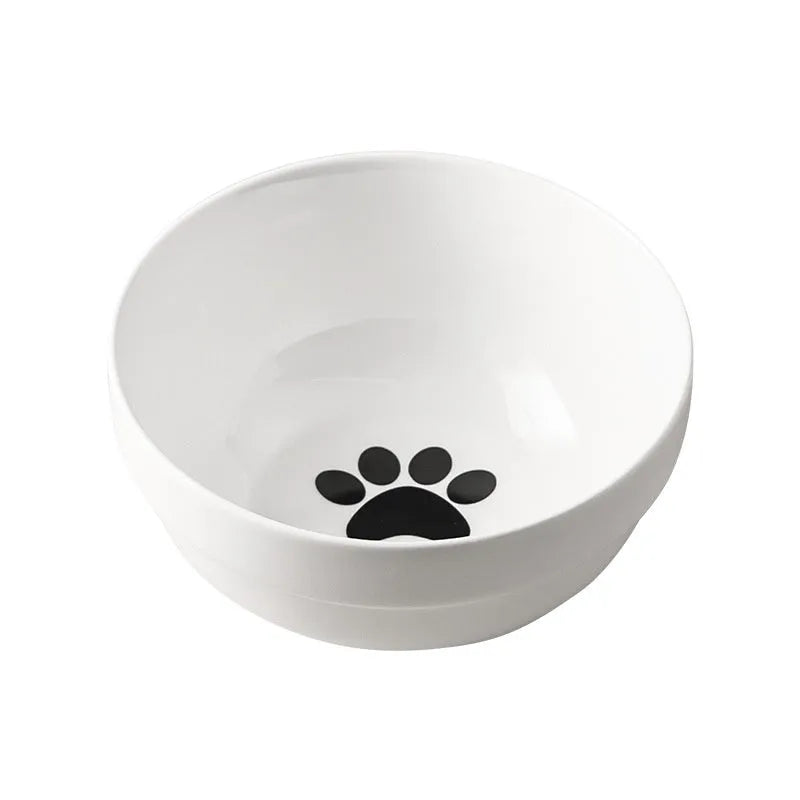 White ceramic cat food bowl with cat paw print design on black iron frame stand