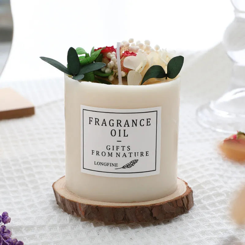 Aromatherapy candle with dried flowers embedded in wax, shown with optional wooden chip base and gift box.