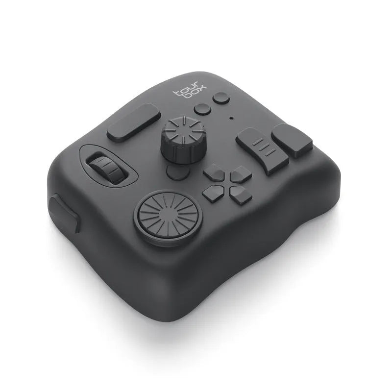 TourBox NEO black creative controller for video editing on a desk next to a tablet.