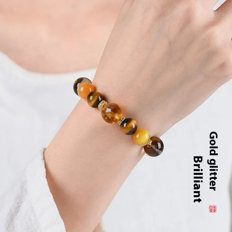 Women's natural yellow 10mm artificial crystal string beads bracelet on wrist.