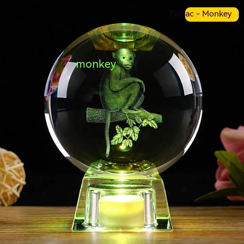 White luminous crystal ball ornament with Chinese zodiac animal figure on electronic base.