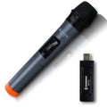 Black ZANSONG V12 dynamic wireless microphone with USB receiver and cables on a table.