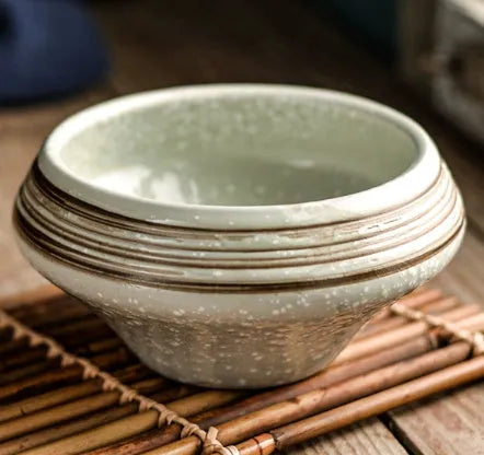 Ceramic tall Japanese soup noodle bowl in a retro glaze colour on a wooden table.