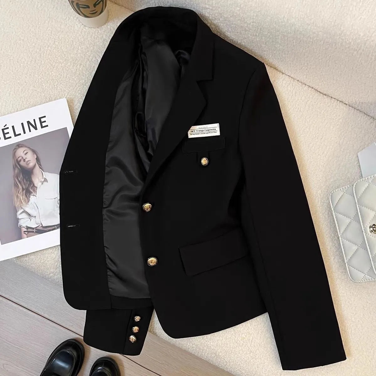 Women's black polyester short suit coat with loose fit and side pockets