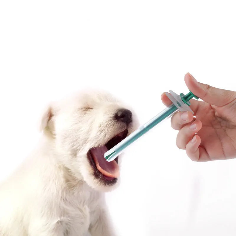 Two silicone pet pill shooter syringes with soft tips on a white background