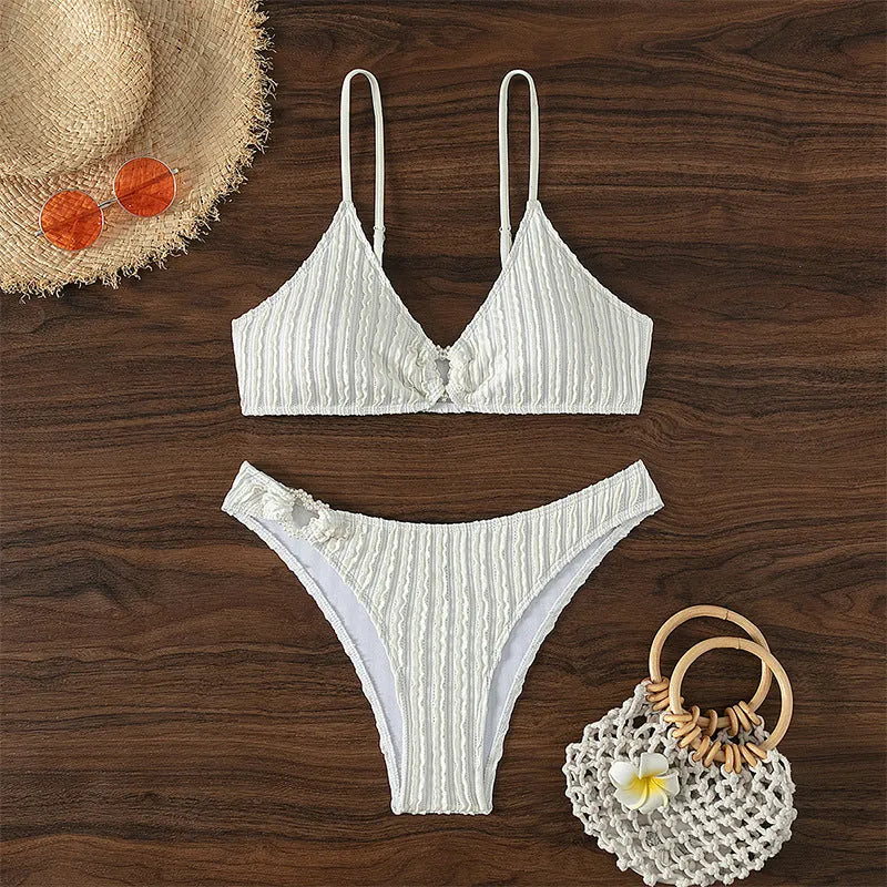 White women's V-neck swimsuit set with matching shorts on hanger