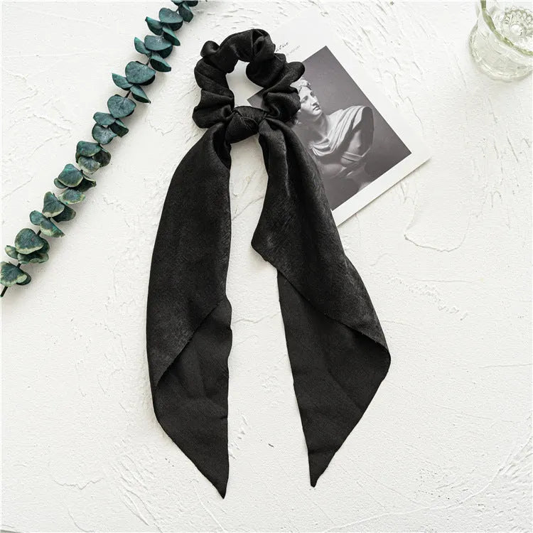 Long spring dark green cloth ribbon attached to a large intestine ring hair accessory for women.