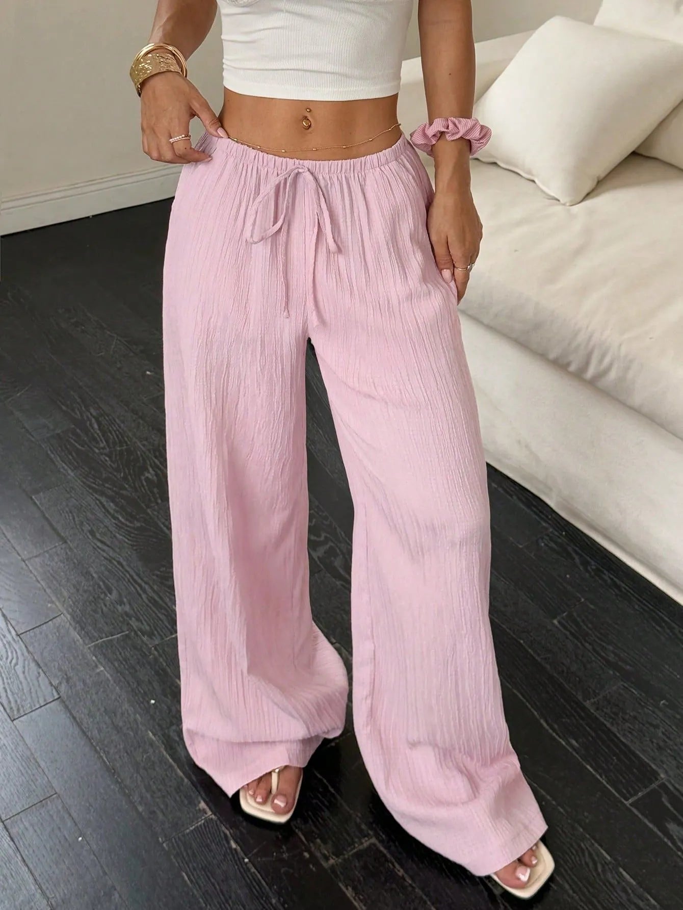 Women's wide leg casual trousers with lace-up waist detail in black and pink.