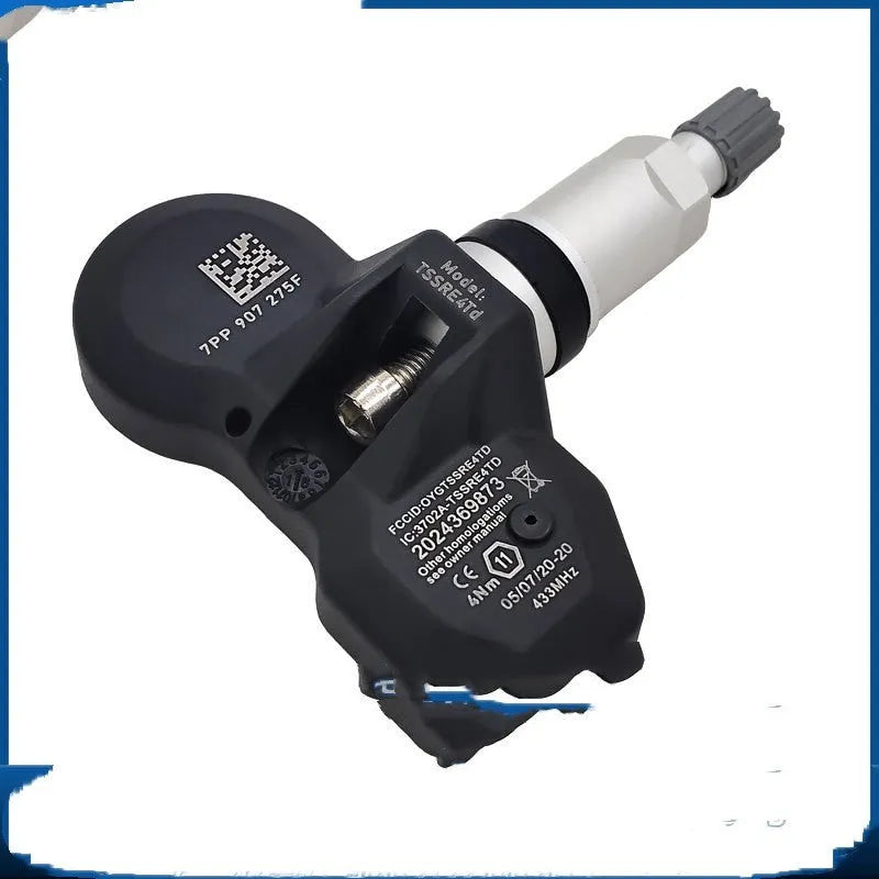 Black car tyre pressure monitor unit for Audi vehicles on white background