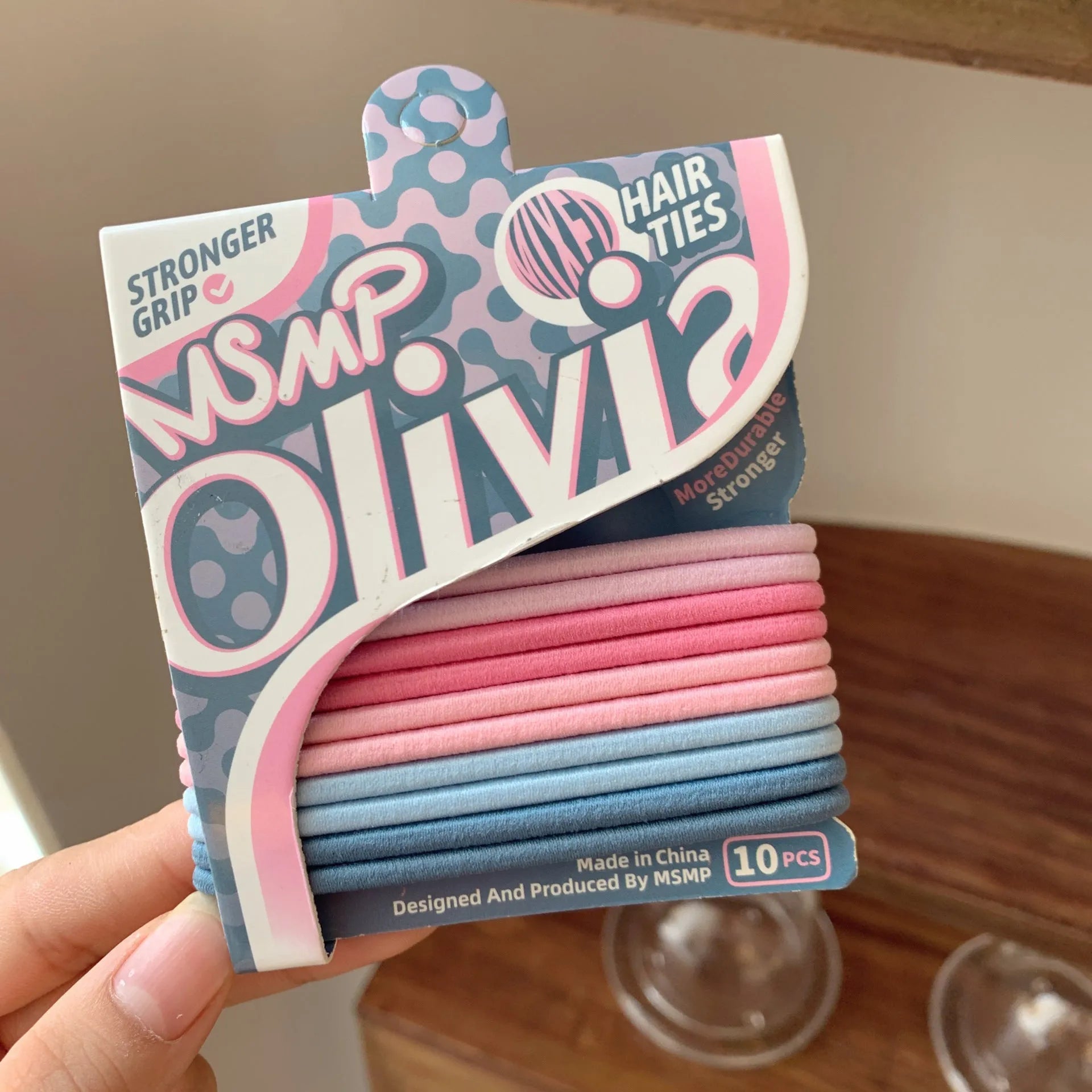 Set of braided elastic hair bands in assorted candy colours on a white background.
