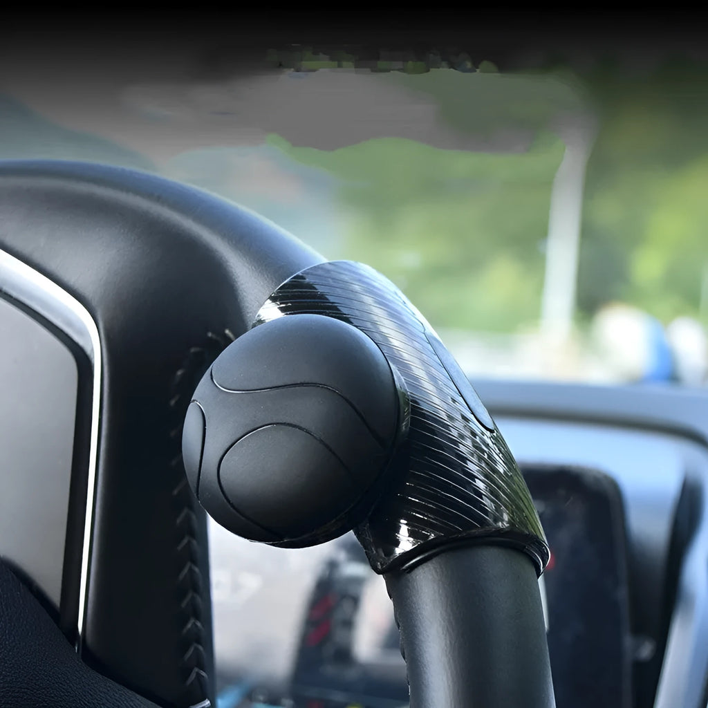 Black and blue silicone steering wheel assist balls with metal bearing boosters showing 9cm by 6cm dimensions