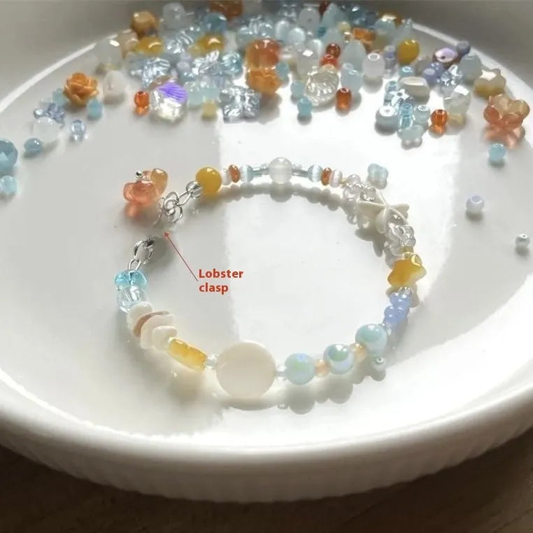 Mixed material alloy bracelet with diamond elements and round detailing in Orange Sea Summer colour
