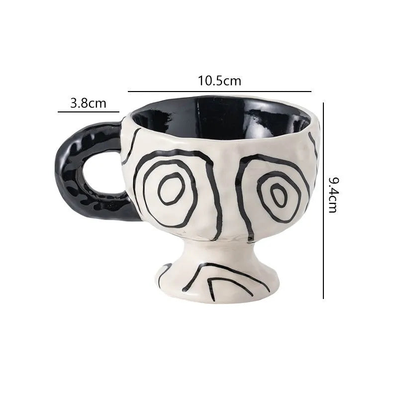 A handmade, irregularly shaped ceramic mug in a solid colour, shown on a table.