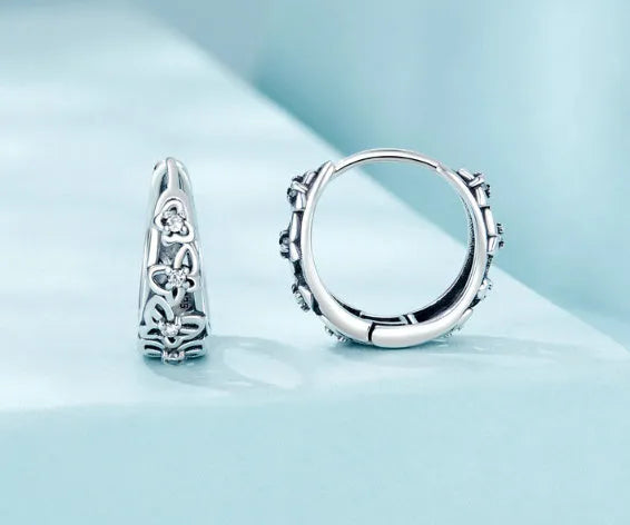 Close-up of women's retro hollow butterfly earrings made from S925 sterling silver with zircon stones.