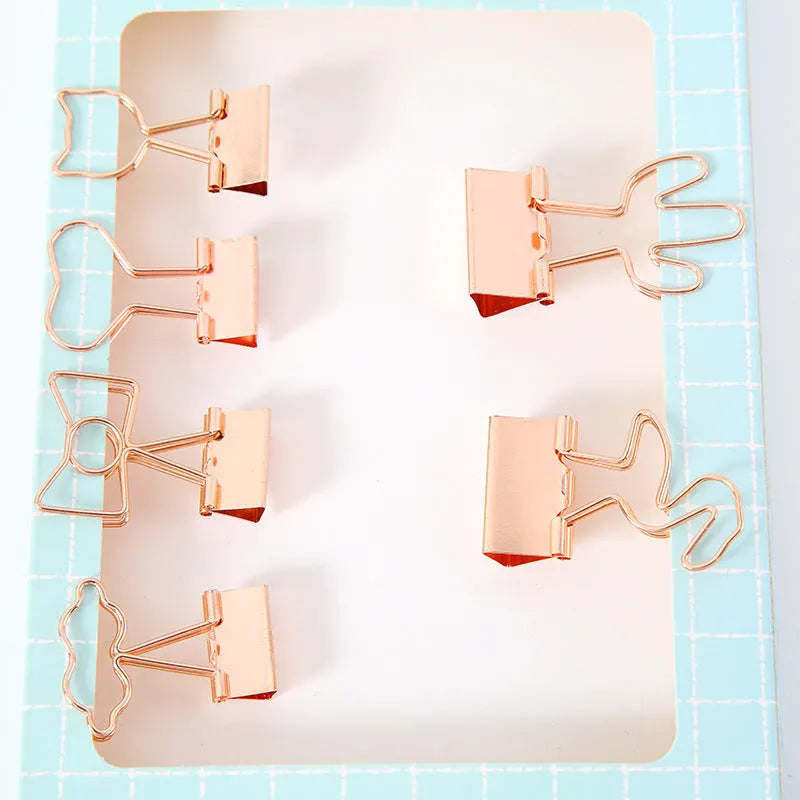 Gold metal decorative paper clip showing flamingo, love, cloud, cat, cactus, and bow shape options.