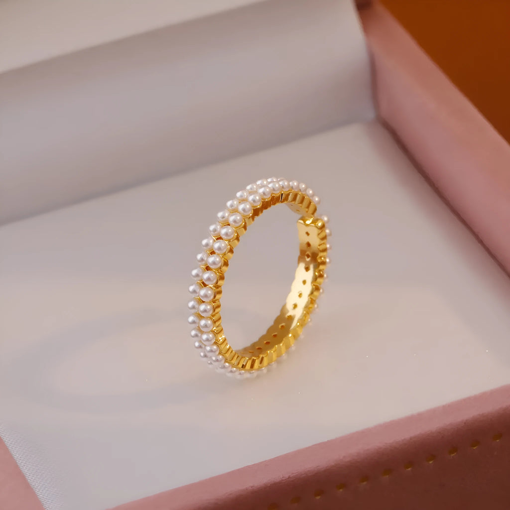 Gold geometry ring with open mouth design and round elements on copper