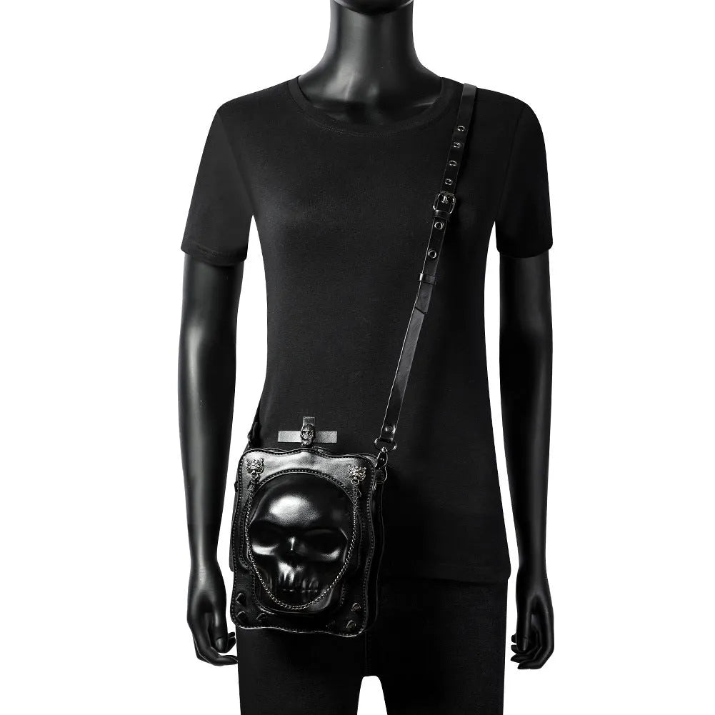 Black mini square crossbody bag with Halloween skull design, chain strap, and Gothic stitching details