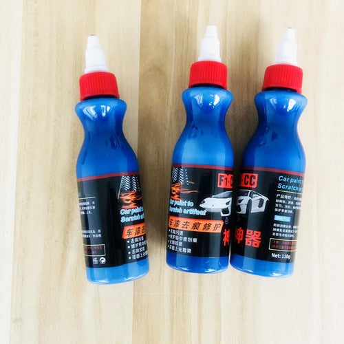 Blue car wiping tool with microfiber applicator and scratch repair agent bottle for automotive paint damage