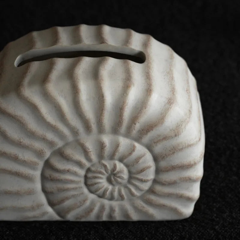 Modern simple resin tissue box cover with decorative conch ramble pattern.