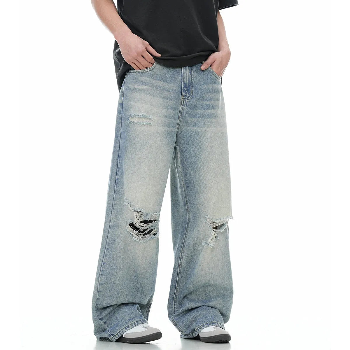 Blue men's straight-leg jeans with ripped distressing detail on the legs.
