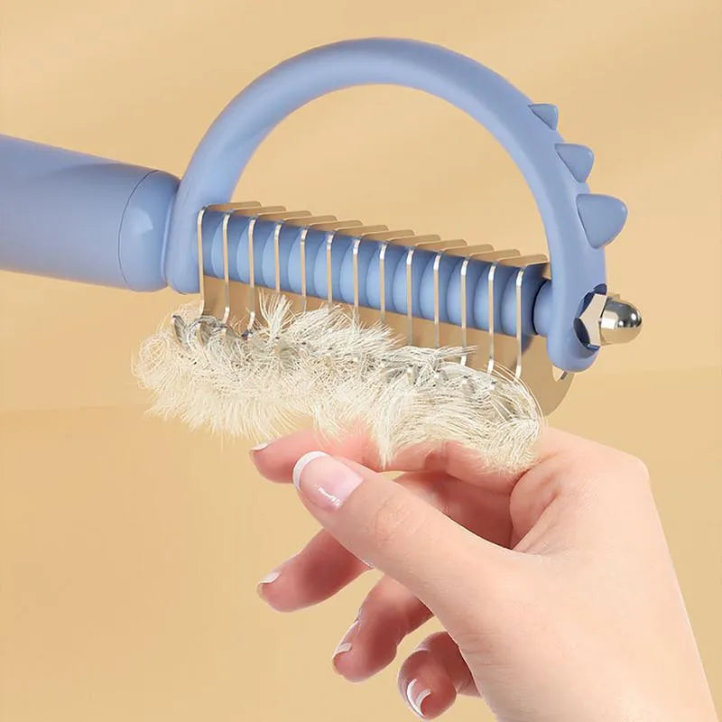 Blue dinosaur-shaped cat brush with stainless steel bristles for self-cleaning grooming