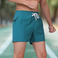 Black men's ice silk polyester fitness shorts with high waist and drawstring.