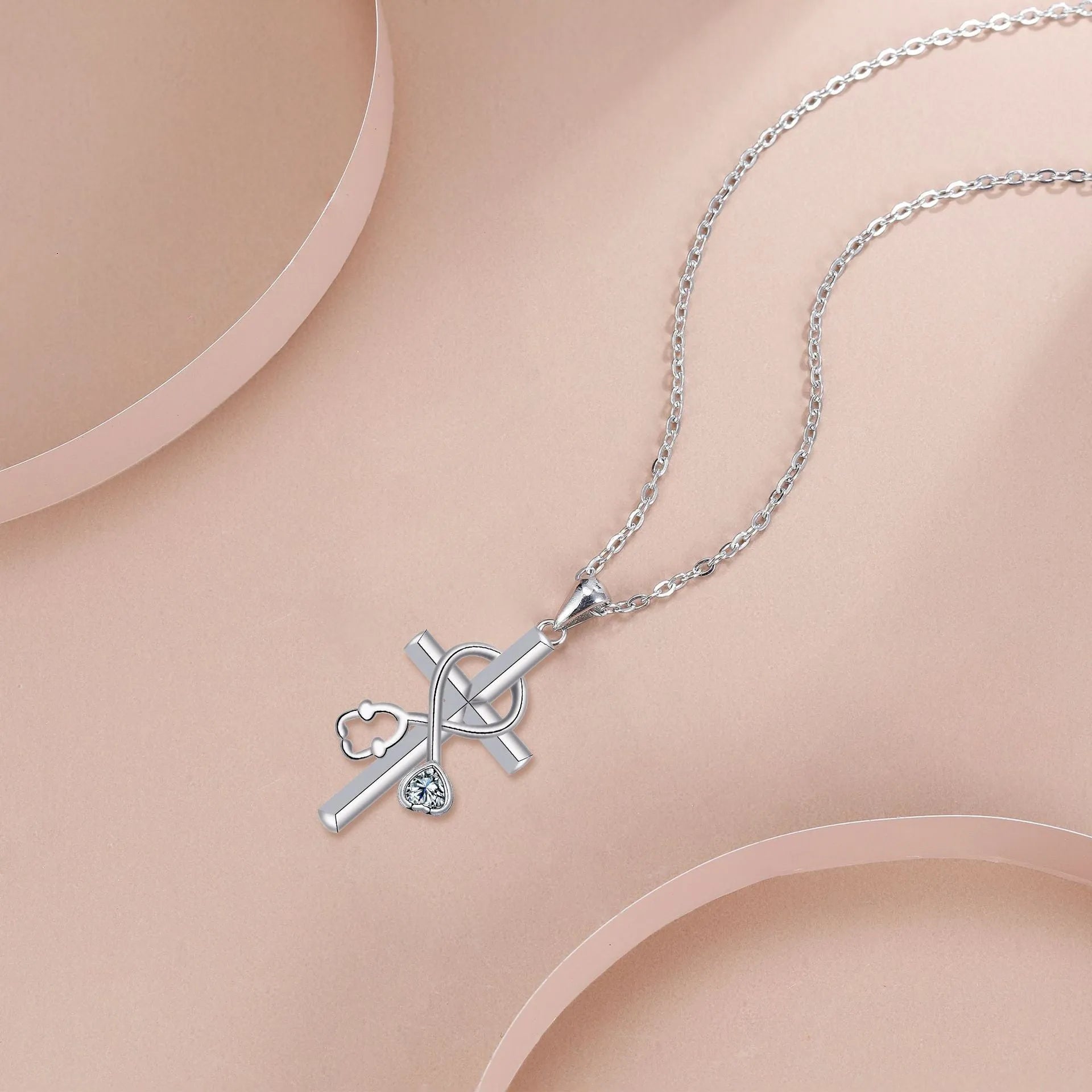 Close-up of a copper stethoscope pendant necklace on a cross chain for medical professionals