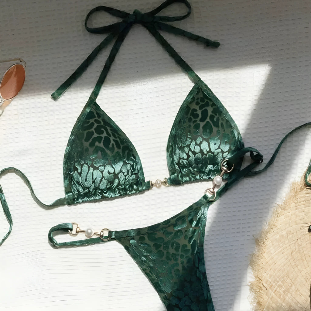 Blue and green leopard print women's bikini set on a mannequin, showing T-shaped design.