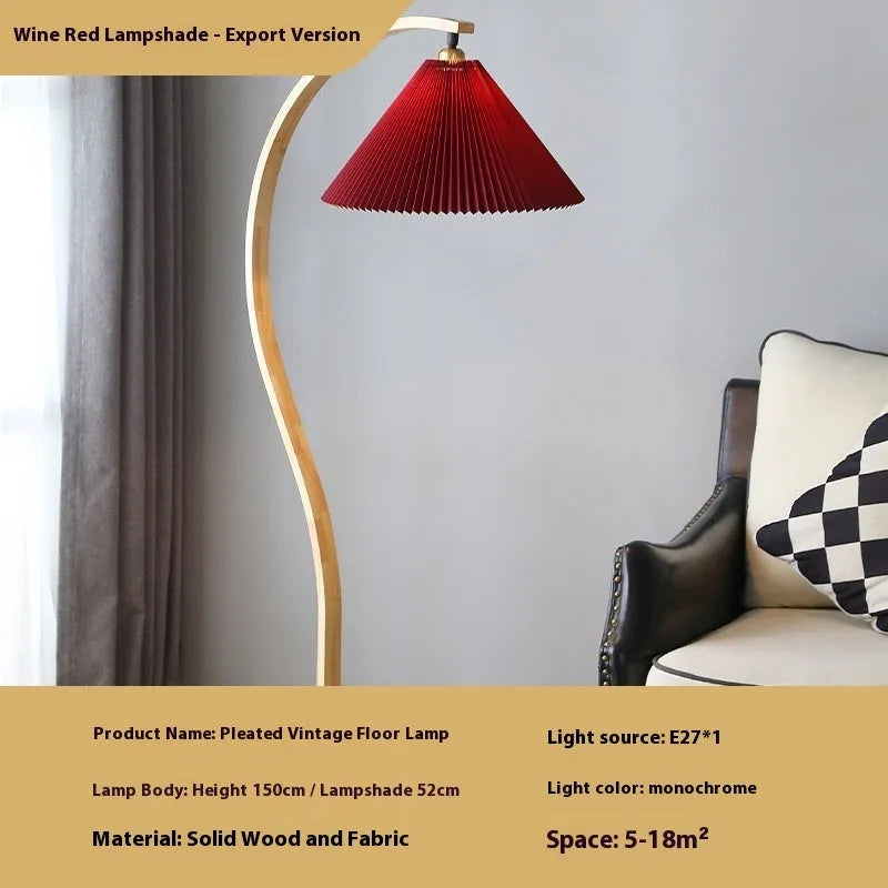 Retro vertical table lamp with fabric shade in choice of colours beside a sofa.