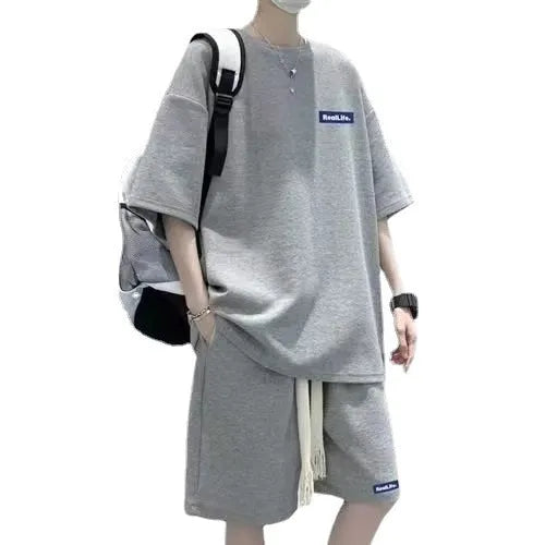 Man wearing a grey waffle knit short sleeve top and matching shorts leisure suit.