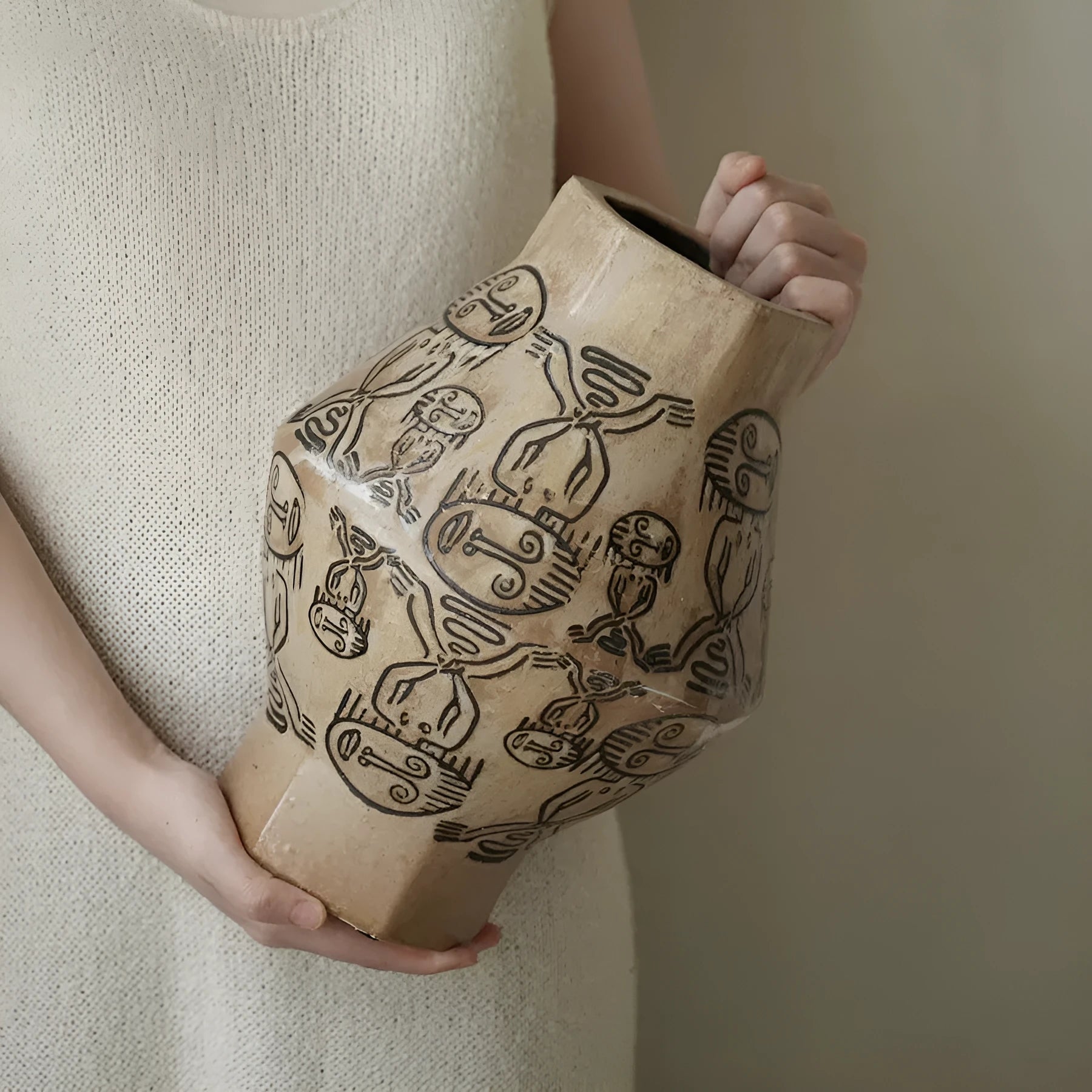 Ceramic vase with hand-painted vintage carved tribal totem art in religious symbolic patterns