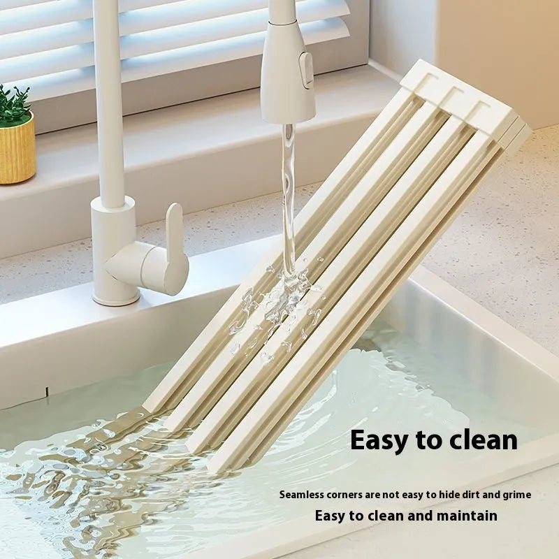 Foldable milky white stainless steel kitchen draining rack shown extended over a sink.