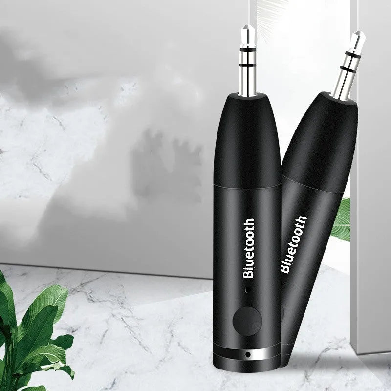Black Bluetooth audio receiver with 3.5mm jack and USB charging port for car stereo connection