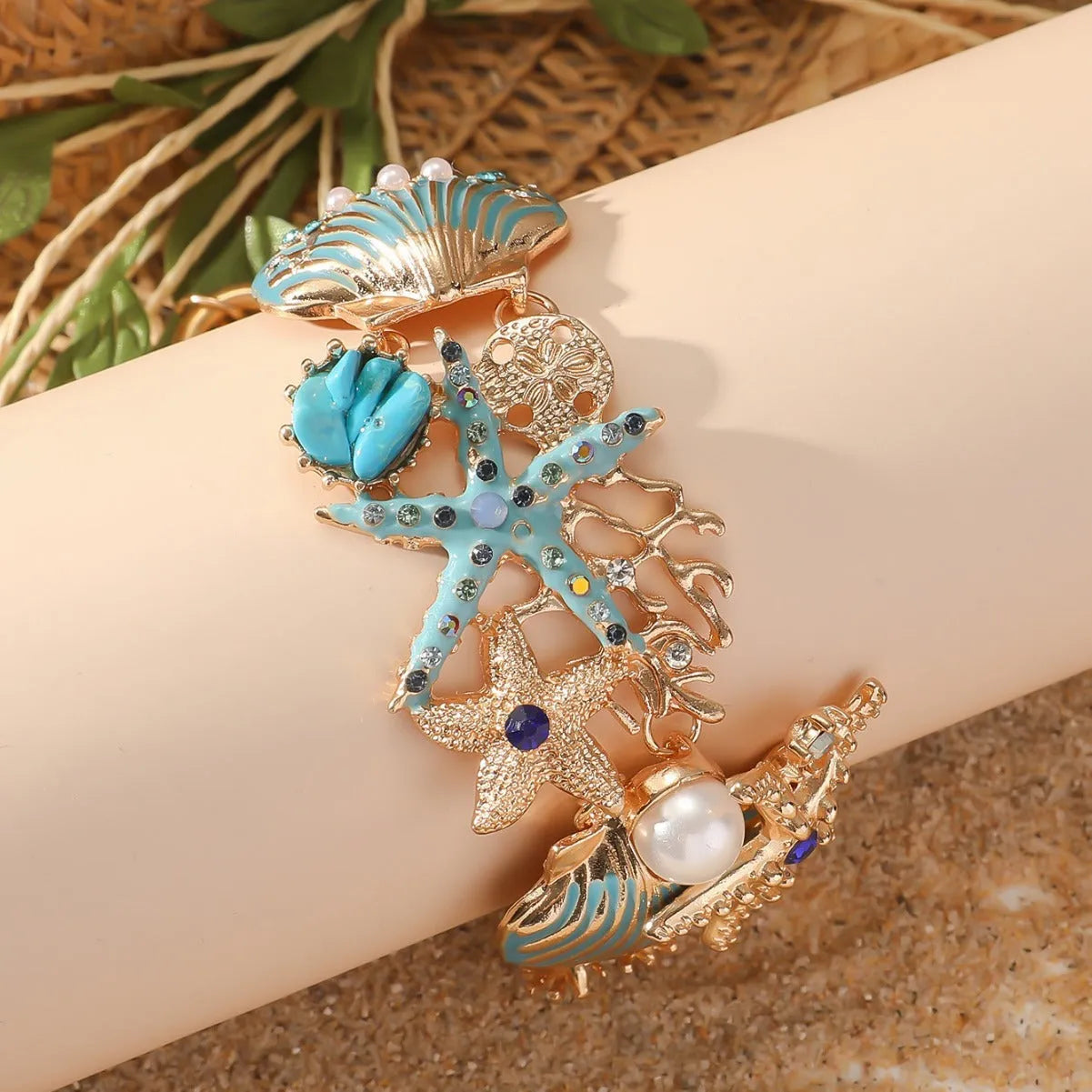Women's alloy bracelet with boat anchor and rhinestone starfish design in turquoise, red, or blue.