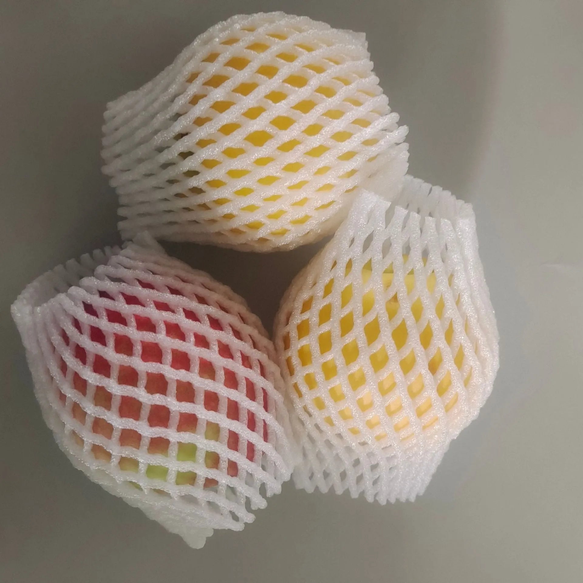 White foam net fruit protective cover shown in various sizes for packing.