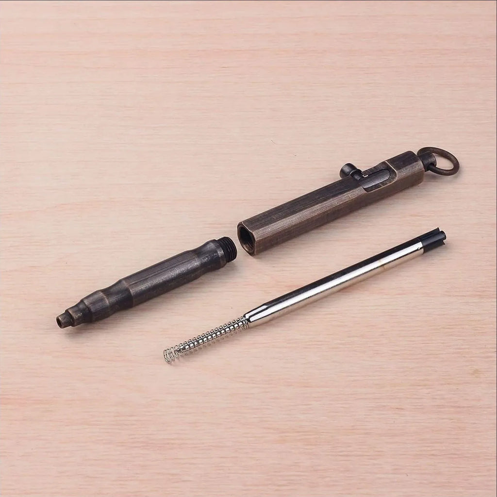 Solid brass tactical pen with hexagonal bolt design on barrel.