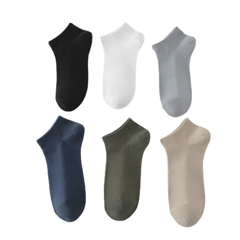 A pair of solid colour low-cut men's boat socks made from breathable polyester fabric.