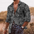 Man wearing a loose-fit long sleeve shirt with a colourful bohemian floral 3D print pattern.