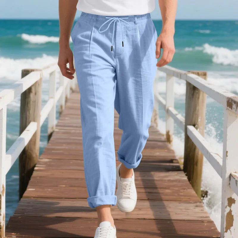 Men's light khaki linen casual trousers with drawstring waist and straight loose leg on hanger.