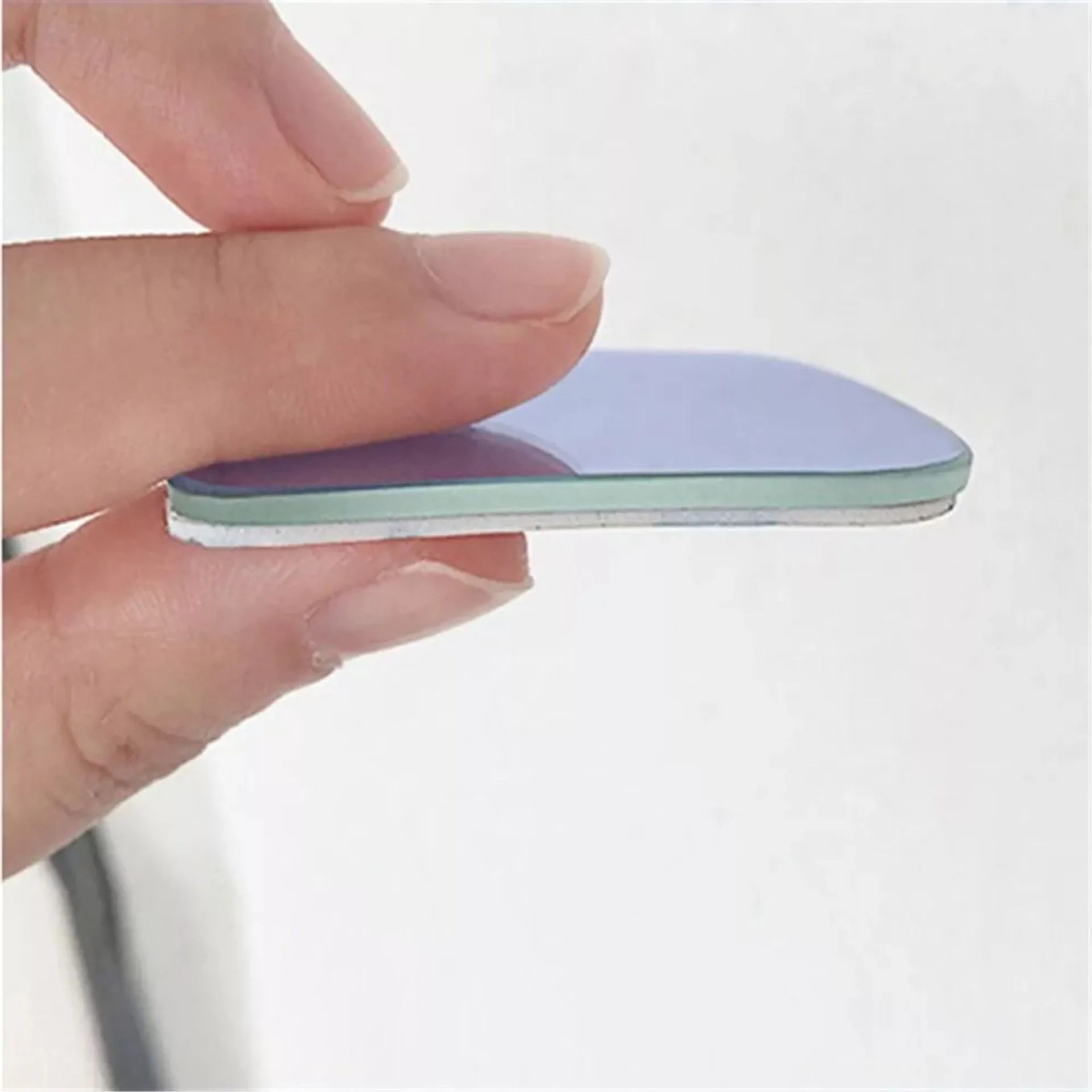 White fan-shaped car blind spot mirror with 360-degree adjustable mount on a universal bracket.