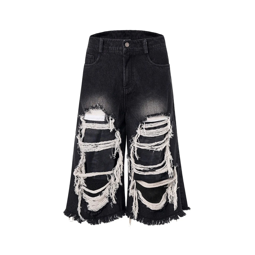 Black cropped wide-leg jeans with mid-high waist and ripped patch details on cotton denim fabric