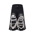 Black cropped wide-leg jeans with mid-high waist and ripped patch details on cotton denim fabric