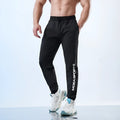 Men's grey sweatpants with adjustable ankle ties, showing mid-waist design and casual sports styling