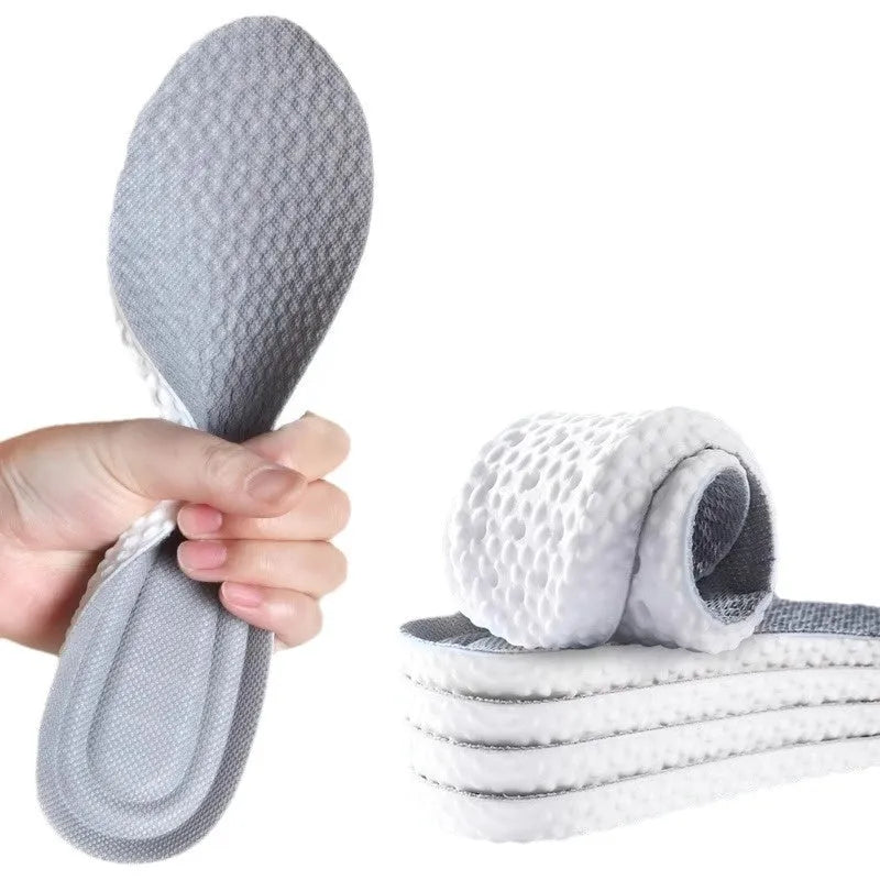 A pair of soft grey PU foam sports insoles with a trimmable edge design on a white background.