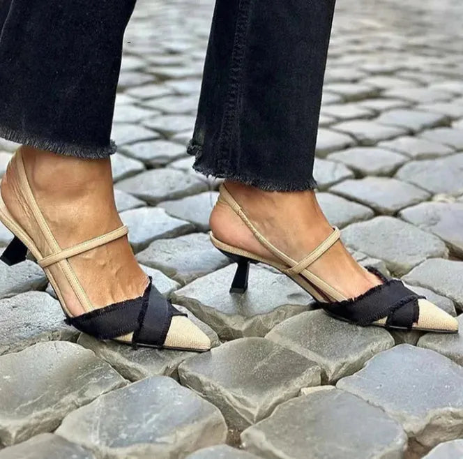 Women's apricot and black colour-block stiletto heel sandals with pointed toe and ankle buckle.