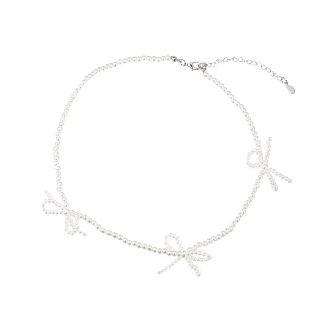 White imitation pearl necklace for women with an adjustable chain and a geometric sweet bow charm.